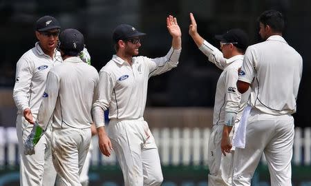 Cricket - India v New Zealand - First Test cricket match - Green Park Stadium, Kanpur - 25/09/2016. New Zealand's players celebrate after taking the wicket of India's Cheteshwar Pujara. REUTERS/Danish Siddiqui