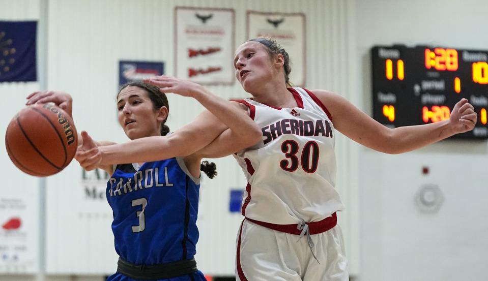 Sheridan Blackhawks Cecilia Timme (30) reaches for a rebound against Carroll Cougars Emily Justice (3) on Thursday, Nov. 9, 2023, during the game at Sheridan High School in Sheridan. The Carroll Cougars defeated the Sheridan Blackhawks, 48-44.