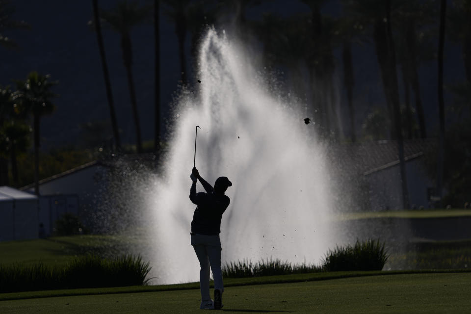 Davis Thompson hits from the fairway to the 18th green during the American Express golf tournament on the La Quinta Country Club Course Thursday, Jan. 19, 2023, in La Quinta, Calif. (AP Photo/Mark J. Terrill)