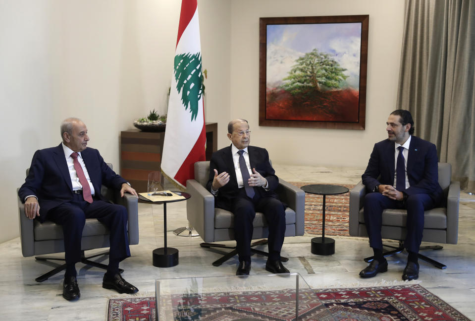 Lebanese President Michel Aoun, center, meets with Prime Minister-Designate Saad Hariri, right, and Lebanese Parliament Speaker Nabih Berri, at the Presidential Palace in Baabda, east of Beirut, Lebanon, Thursday, Oct, 22, 2020. Lebanon's president Michel Aoun asked former premier Saad Hariri to form the country's next government Thursday after he secured enough votes from lawmakers - bringing back an old name to lead the country out of its dire political and economic crises. (Anwar Amro, Pool via AP)