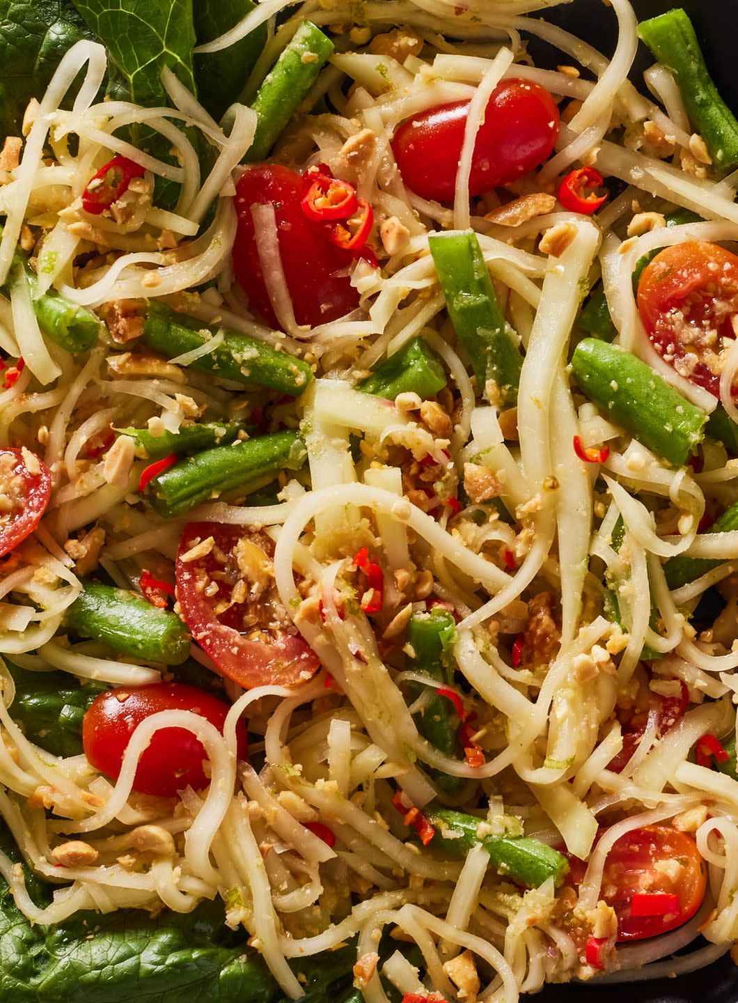 green papaya salad with tomatoes and romaine and crushed peanuts