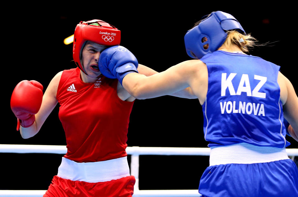 LONDON, ENGLAND - AUGUST 06: Marina Volnova of Kazakhstan (Blue) competes against Savannah Marshall (Red) of Great Britain during the Women's Middle (75kg) Boxing Quarterfinals on Day 10 of the London 2012 Olympic Games at ExCeL on August 6, 2012 in London, England. (Photo by Scott Heavey/Getty Images)