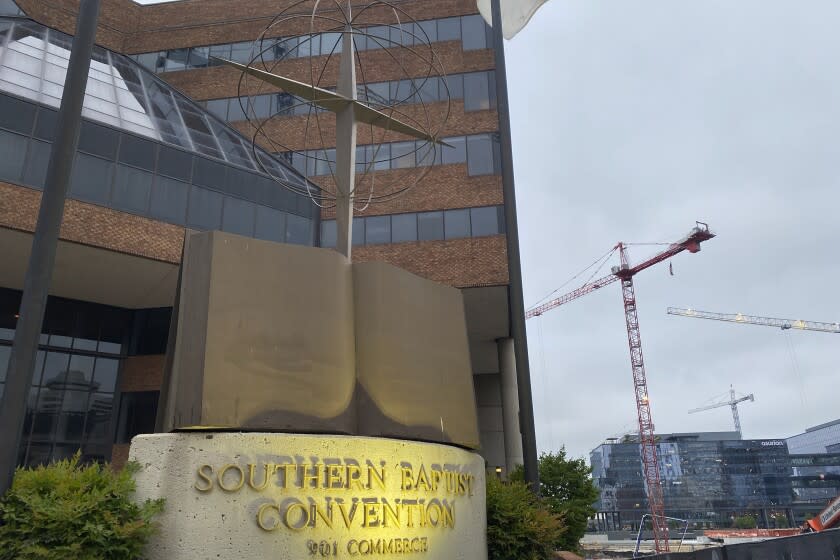 A cross and Bible sculpture stand outside the Southern Baptist Convention headquarters in Nashville, Tenn., on Tuesday, May 24, 2022. On Tuesday, top administrative leaders for the SBC, the largest Protestant denomination in America, said that they will release a secret list of hundreds of pastors and other church-affiliated personnel accused of sexual abuse. (AP Photo/Holly Meyer)