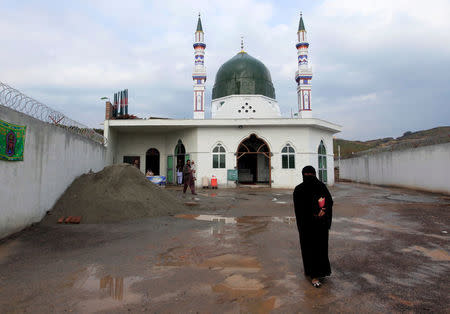 FILE PHOTO A woman leaves after visiting a shrine where the grave of Mumtaz Qadri is situated, the man Pakistan executed last year for assassinating a governor who proposed reforming the country’s blasphemy laws, on the outskirts of Islamabad, Pakistan, January 5, 2017. REUTERS/Faisal Mahmood/File Photo