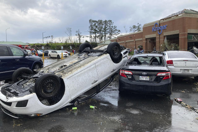A car is upturned in a Kroger parking lot after severe storm swept through Little Rock, Ark., Friday, March 31, 2023. (Andrew DeMillo / AP)