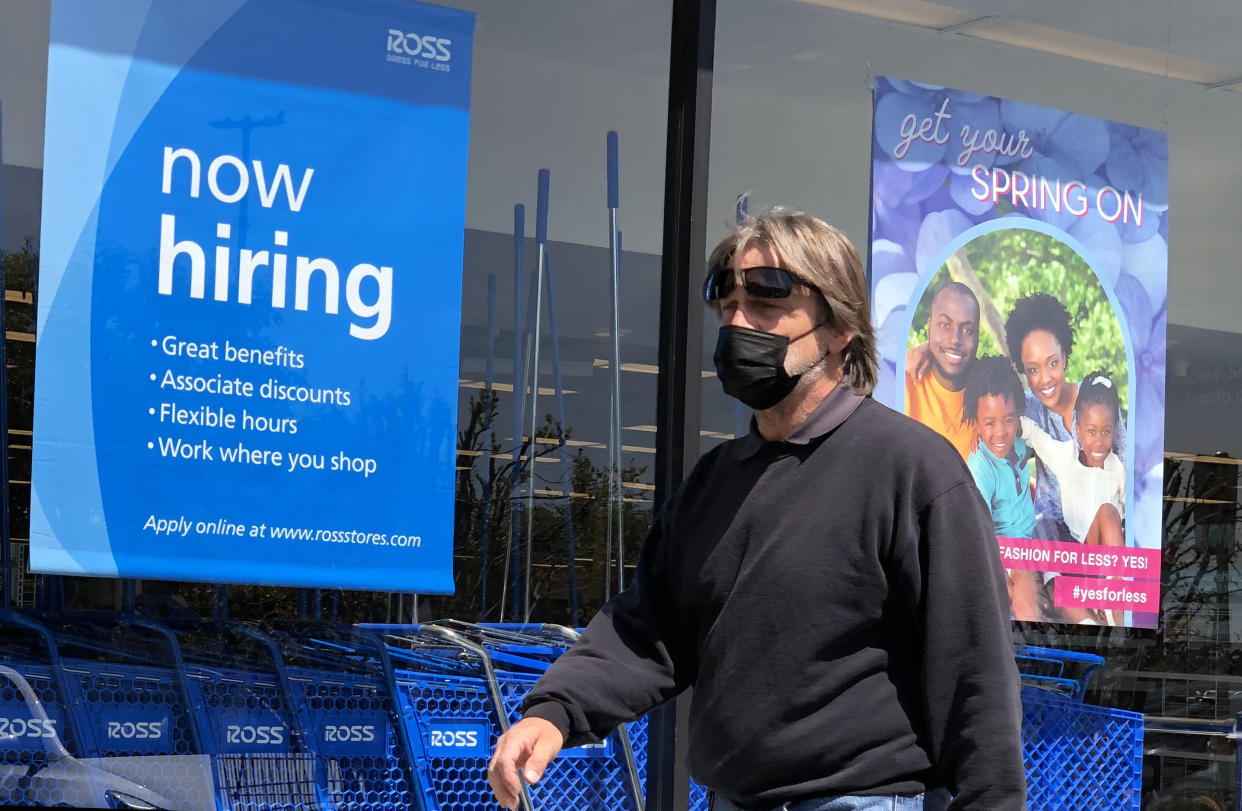 A pedestrian walks by a now hiring sign at Ross Dress For Less store on April 02, 2021 in San Rafael, California. According to a report by the Bureau of Labor Statistics, the U.S. economy added 916,000 jobs in March and the unemployment rate dropped to 6 percent. (Justin Sullivan/Getty Images)