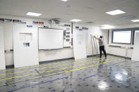 A Covid testing area is constructed at Great Academy Ashton, as the school prepares for its reopening on March 8 after the latest lockdown curb the spread of coronavirus, in Ashton-Under-Lyne, England, Thursday, March 4, 2021. The school with approximately 1300 pupils aged 11 to 16 in Greater Manchester will have to conduct around 450 tests per day on pupils and staff in the first 2 weeks after the return of students on Monday. (AP Photo Jon Super)