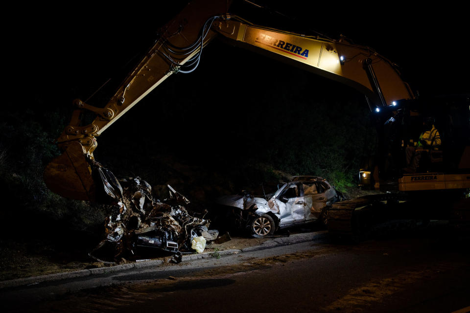 Workers pull what remains of a car from a sinkhole that opened up in the Chatsworth neighborhood of Los Angeles on Jan 10.<span class="copyright">Alex Welsh for TIME</span>