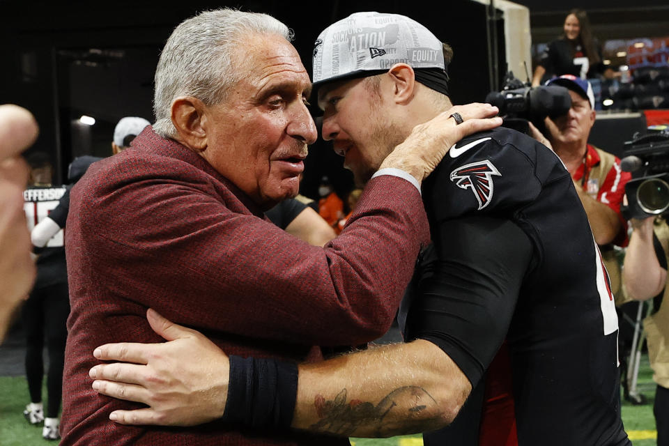 Atlanta Falcons owner Arthur Blank embraces quarterback Taylor Heinicke after an NFL football game against the Indianapolis Colts, Sunday, Dec. 24, 2023, in Atlanta. The Atlanta Falcons won 29-10. (AP Photo/Alex Slitz)