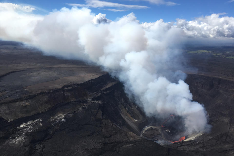 A plume rises near active fissures in the crater of Hawaii's Kilauea volcano on Monday, Dec. 21, 2020. People are lining up to try to get a look at the volcano on the Big Island, which erupted last night and spewed ash and steam into the atmosphere. A spokeswoman for Hawaii Volcanoes National Park says the volcanic activity is a risk to people in the park Monday and that caution is needed. (M. Patrick/U.S. Geological Survey via AP)