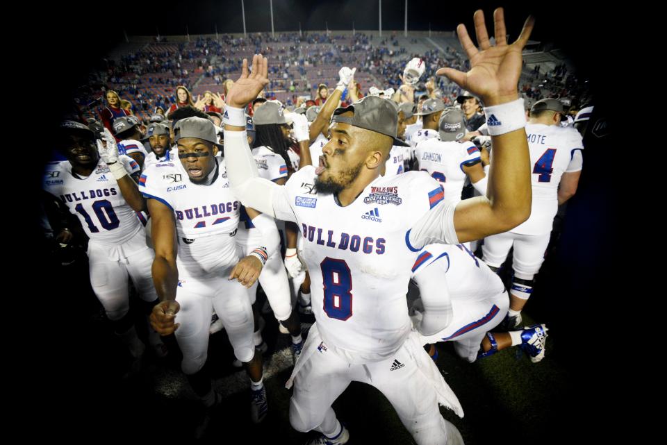 Louisiana Tech's J'Mar Smith (8) celebrates with his team when the Bulldogs won the 2019 Walk-On's Independence Bowl against the Miami Hurricanes in Shreveport's Independence Stadium.