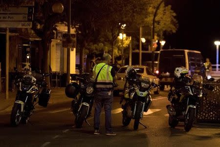 A police officer stands near the scene where police had killed four attackers in Cambrils, south of Barcelona, Spain, August 18, 2017. REUTERS/Stringer