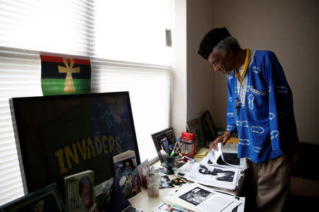 Activist Sweet Willie Wine looks through papers near his framed "Memphis Invaders" (a black power group) jacket in Memphis, Tennessee, U.S., March 29, 2018. After spending time in prison as a young man, the assassination of Martin Luther King Jr. inspired Wine to dedicate his life to the Civil Rights movement. He was three blocks away from the Lorraine Motel when King was killed on April 4, 1968. "On Friday, April the 5th, his body was at Lewis' Funeral Home. Something said to me, "Get up and go down to Lewis's Funeral Home," said Wine. "I went in and over him I said, 'Dr. King, I'm gonna make them pay.' That's when I made my commitment. That was fifty years ago, and I've not turned around since." REUTERS/Jonathan Ernst