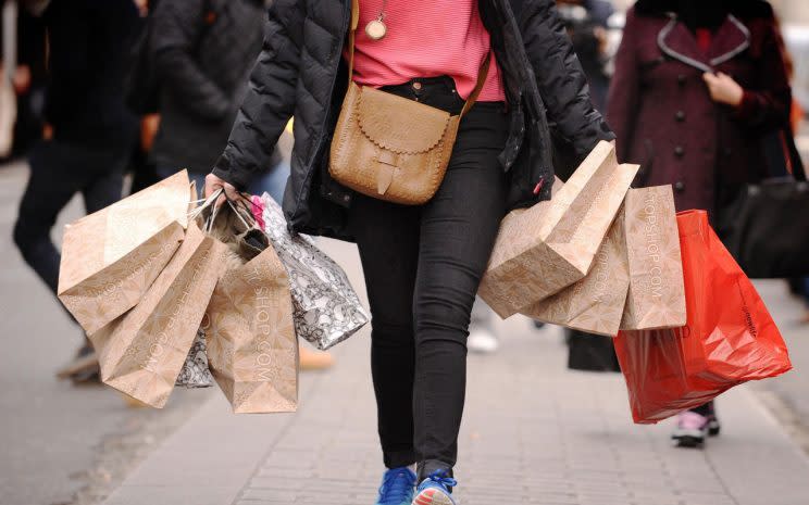 Woman shopping in the High Street/PA Photos