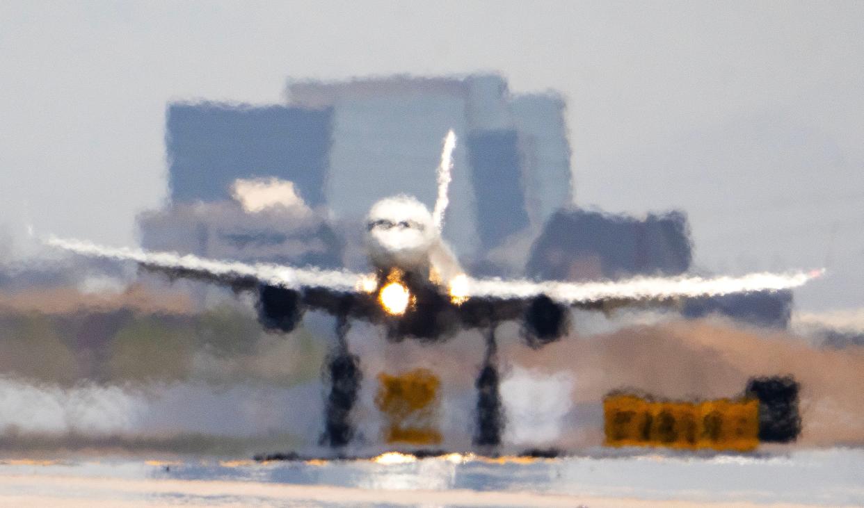 Heat shimmer causes visual distortion as Delta Airlines flight DL796 from Atlanta touches down at Sky Harbor International Airport in Phoenix on July 14, 2023, the 15th day in a row temperatures reached 110 degrees or more.