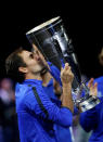 Tennis - Laver Cup - 3rd Day - Prague, Czech Republic - September 24, 2017 - Roger Federer of team Europe kisses the trophy after winning the tournament. REUTERS/David W Cerny