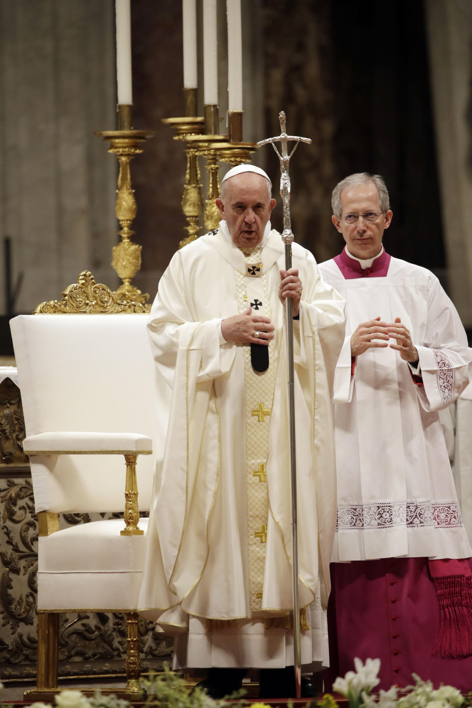 Pope Francis, flanked by master of ceremonies Monsignor Guido Marini, holds the pastoral staff during a ceremony in which he ordained nineteen new priests in St.Peter's Basilica, at the Vatican, Sunday, May 12, 2019. (AP Photo/Alessandra Tarantino)