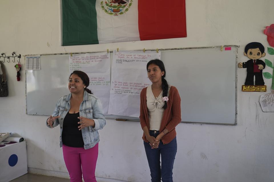 Liz Vázquez, left, speaks and Maria Leticia Santiz translates into the Tojolabal language, during a workshop with a co-ed class about gender equality at a school in Plan de Ayala, a Tojolabal village in the Las Margaritas municipality of Chiapas state, Mexico, Thursday, May 2, 2024. Vázquez and Santiz aim to encourage conversation and reflection in some of Chiapas’ most closed communities, learn the realities of people there, and provide tools to improve their lives. (AP Photo/Marco Ugarte)