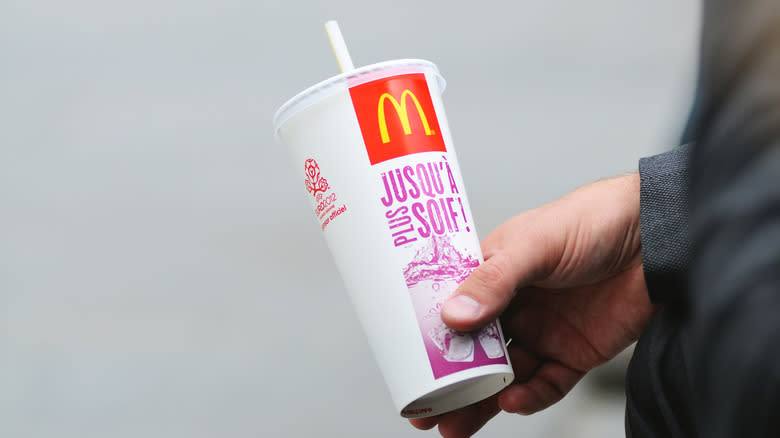 Hand holding McDonald's cup