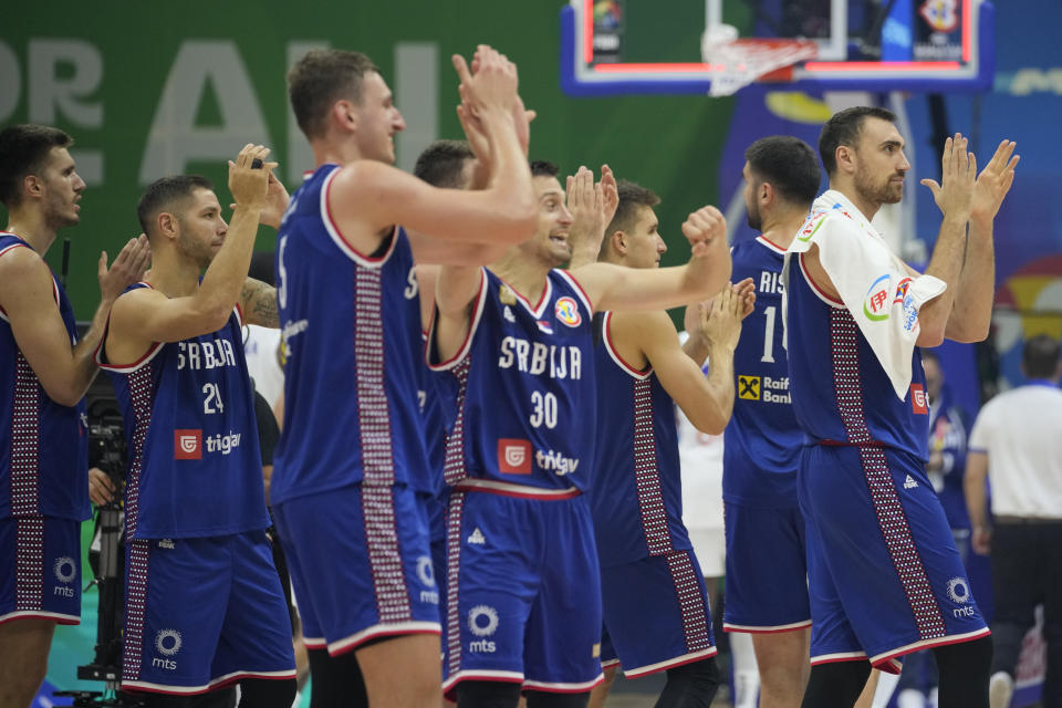 Serbia team celebrate after winning against Dominican Republic during their Basketball World Cup second round match at the Araneta Coliseum, Manila, Philippines on Sunday Sept. 3, 2023. (AP Photo/Aaron Favila)