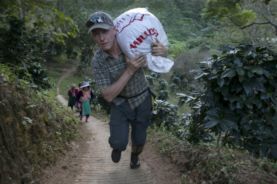 ay Buerger, owner of Thai High Ventures, carries a large bag of freshly picked coffee beans at the Thai High coffee farm in Phrao, northern Thailand. The organic fair trade coffee farm was chosen to help produce the Black Ivory Coffee. The new brand of coffee is produced by harvesting the beans from the dung of a Thai elephant.