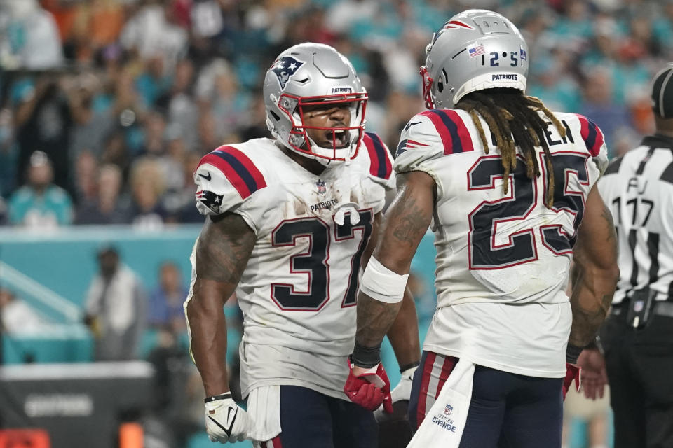 New England Patriots running back Damien Harris (37) celebrates with New England Patriots running back Brandon Bolden (25) after scoring a touchdown during the second half of an NFL football game, Sunday, Jan. 9, 2022, in Miami Gardens, Fla. (AP Photo/Lynne Sladky)