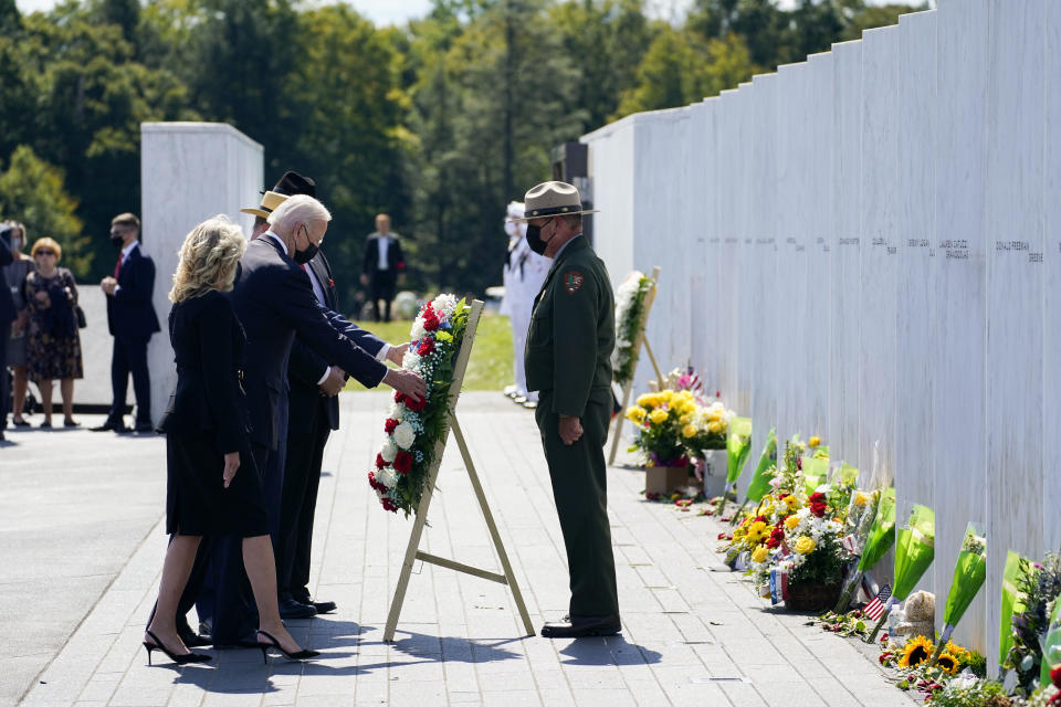 President Joe Biden and first lady Jill Biden lay a wreath at the Wall of Names during a visit to the Flight 93 National Memorial in Shanksville, Pa., Saturday, Sept. 11, 2021. The Bidens visited to commemorate the 20th anniversary of the Sept. 11, 2001, terrorist attacks. Gordon Felt, brother of Edward Porter Felt and President of Families for Flight 93, third from right, Calvin Wilson the brother-in-law of First Officer LeRoy Homer, a passenger on Flight 93, second from right, and National Park Service park ranger Robert Franz, right, look on. (AP Photo/Evan Vucci)