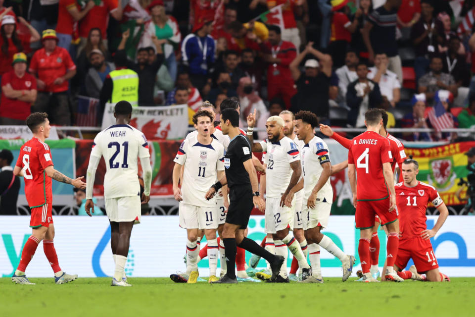 USA's Tyler Adams and Brenden Aaronson are seen among players appealing Referee Abdulrahman Al Jassim of Qatar's decision to award Wales a penalty for a foul on November 21, 2022.<span class="copyright">Youssef Loulidi—Fantasista/Getty Images</span>