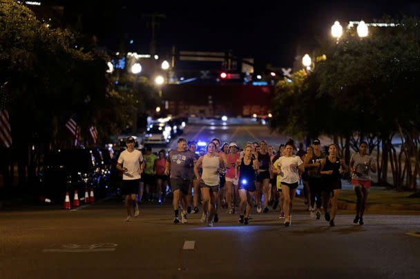 PHOTO: Runners make their way down Main Street in Tupelo, Miss. as they hold their 'Liza's Lights' run early Friday morning, Spet. 9, 2022, in Tupelo Miss. (The Northeast Mississippi Daily Journal via AP)