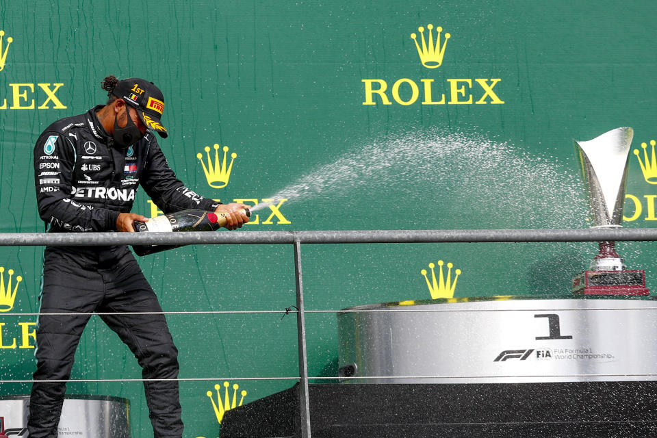 Mercedes driver Lewis Hamilton of Britain steers celebrates on the podium after winning the Formula One Grand Prix at the Spa-Francorchamps racetrack in Spa, Belgium, Sunday, Aug. 30, 2020. (Francois Lenoir/Pool Photo via AP)