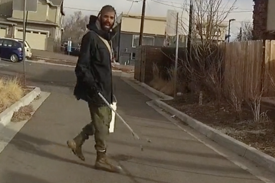 A police officer who was criticised after pulling a gun on a college student picking up rubbish outside his home in March has resigned after being investigated for the incident.Zayd Atkinson, a student at Naropa University in Boulder, Colorado, was picking up garbage outside of his residence when officer John Smyly approached. Mr Smyly attempted to detain Mr Atkinson, and asked for proof that Mr Atkinson lived on the property. When Mr Atkinson, a black student, produced his student identification card to the white officer demanded further proof. Mr Atkinson said he felt racially profiled by the incident.Body camera footage indicates Mr Atkinson responded “I’m a student, I live here ... I’m doing my job”, and continued to collect garbage. The officer then called for back-up, leading to eight officers surrounding the college student.Mr Smyly said that the student, who was black, was “probably going to get tased”. The officer proceeded to pull out his gun, citing that the trash clamp could be used as a weapon. “You’re on my property with a gun in your hand, threatening to shoot me because I’m picking up trash,” Mr Atkinson said during the altercation. “I don’t have a weapon. This is a bucket. This is a clamp.”The report released with the body camera footage noted the officer did not have authority to detain Mr Atkinson, or probable cause to charge him with any crime. An internal investigation indicated that Mr Smyly had violated two department policies on public trust and conduct, but it was not proven that the incident was racially motivated. Mr Smyly resigned from his position under a settlement that allows him to remain on the department payroll until February of 2020, earning benefits, holiday time, and a salary, as reported by BBC.