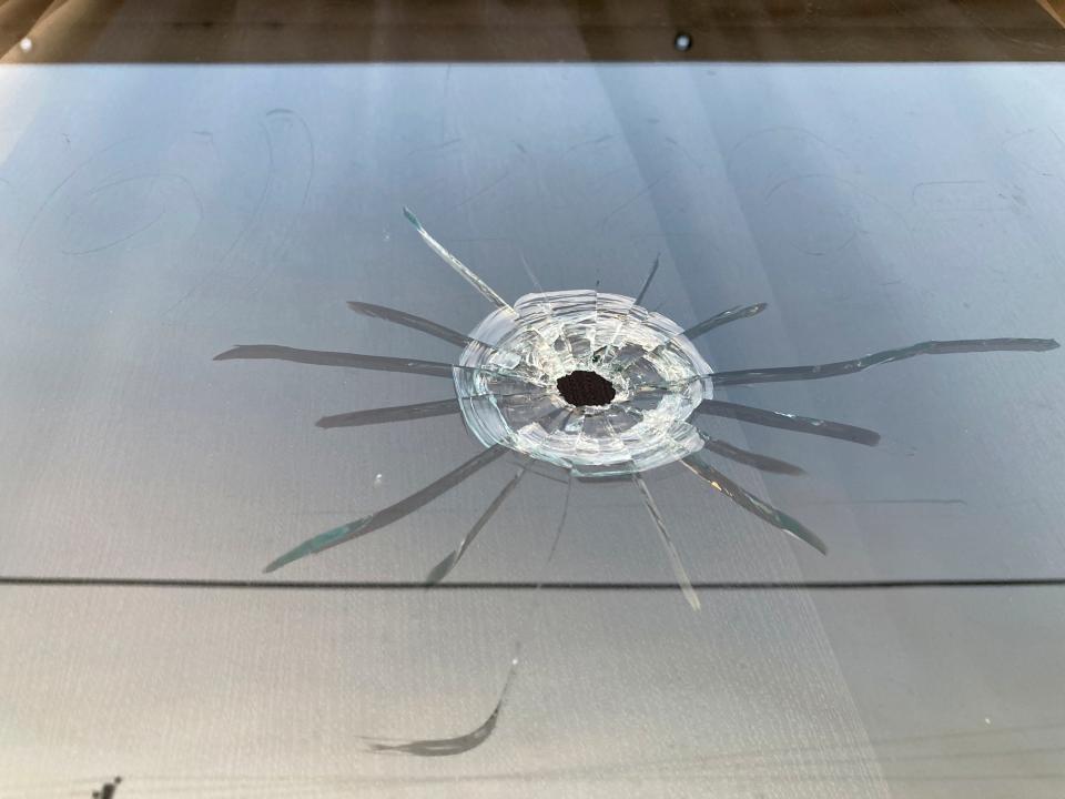 A bullet hole is visible in the glass transom over the door at Mahogany Masterpiece (Jeff Amy/AP)