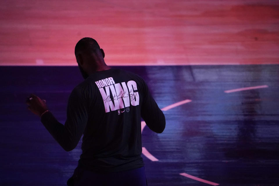 Los Angeles Lakers' LeBron James wears a T-shirt honoring Martin Luther King Jr. before the team's NBA basketball game the Golden State Warriors, Monday, Jan. 18, 2021, in Los Angeles. (AP Photo/Jae C. Hong)