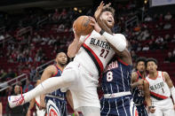 Portland Trail Blazers center Jusuf Nurkic (27) drives to the basket as Houston Rockets forward Jae'Sean Tate (8) defends during the first half of an NBA basketball game, Friday, Jan. 28, 2022, in Houston. (AP Photo/Eric Christian Smith)