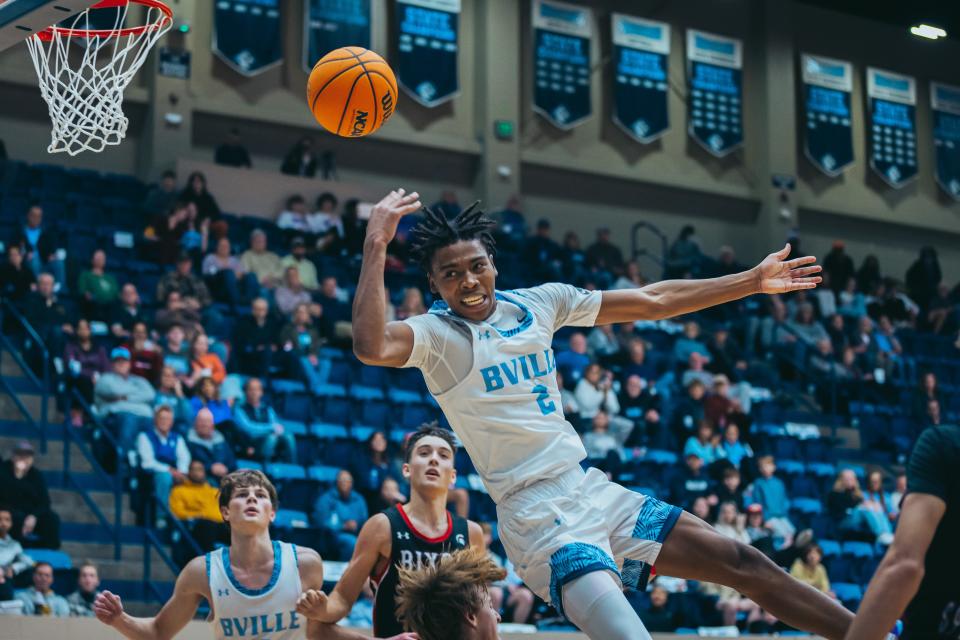 Bartlesville's Michael Smith III takes a hard blocking foul during Tuesday night's games against Bixby.