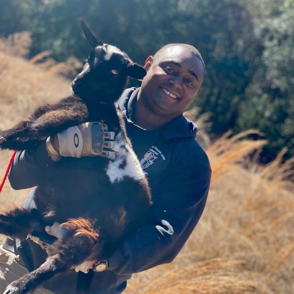 Tony U. Brown, Southern CC Inc. founder, with a goat that is being raised on his organization's farm in Fayetteville, North Carolina.