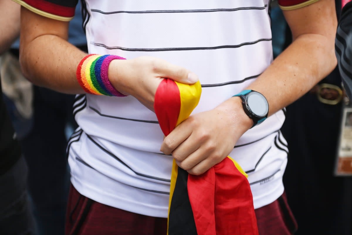 A Germany fan wears the rainbow colours on their wrist in Doha (EPA)