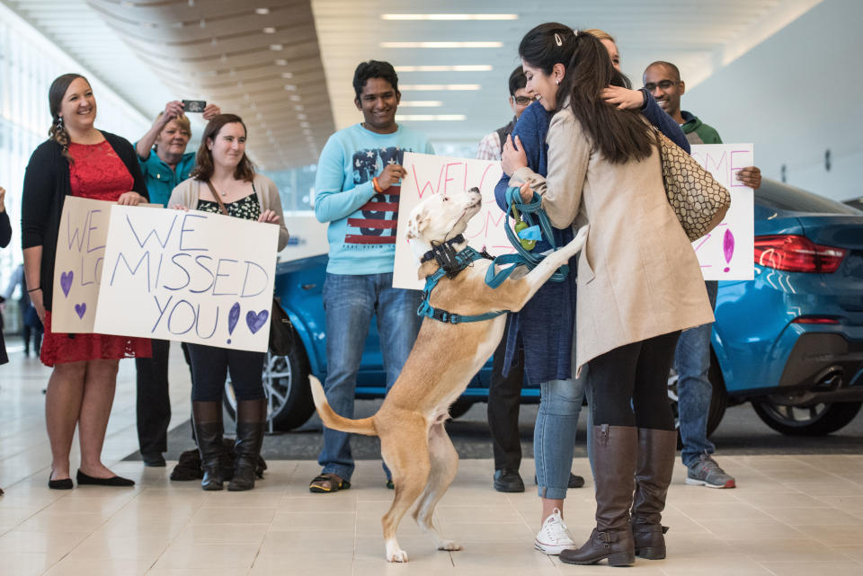 Iranian engineer Nazanin Zinouri, with her dog Dexter, gets a hug from Emma Porter after arriving at the Greenville Spartanburg Airport Feb. 6, 2017 in Greenville, South Carolina. Zinouri, a Clemson graduate, works for a technology firm in Greenville and has lived in the United States for the past seven years. While attempting to return to South Carolina after a recent trip visiting family in Iran, she had been taken off her flight in Dubai as a result of Trump's travel and immigration&nbsp;order.