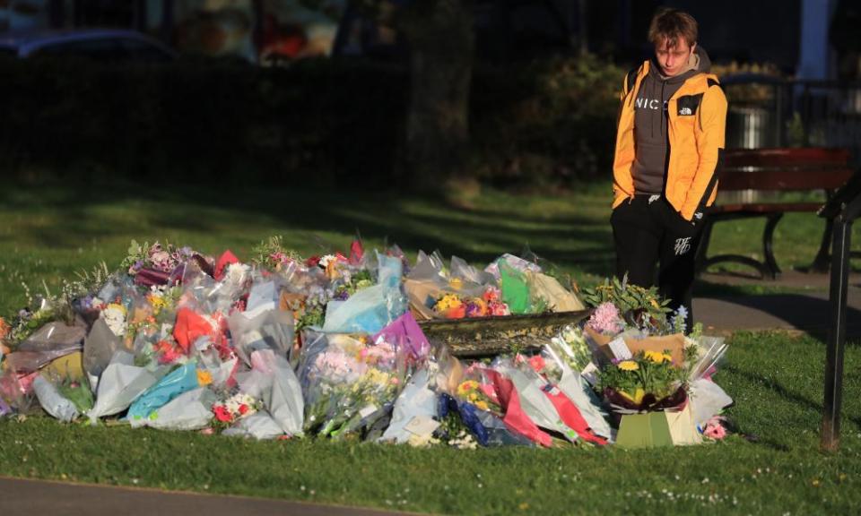 Patrick James, the son of PCSO Julia James, looks at floral tributes left near her family home in Snowdown, near Aylesham, east Kent.