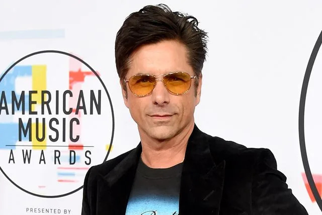 <p>Kevin Mazur/Getty</p> John Stamos at the 2018 AMAs