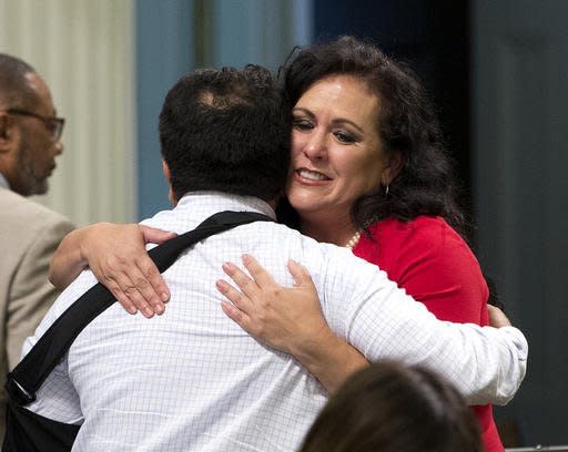 Assemblywoman Lorena Gonzalez, D-San Diego, receives congratulations from Assemblyman Jimmy Gomez, D-Los Angeles after the Assembly approved her bill requiring farmworkers to receive overtime pay after working eight hours, at the Capitol, Monday, Aug. 29, 2016, in Sacramento, Calif. The measure, AB1066, now goes to the governor. (AP Photo/Rich Pedroncelli)