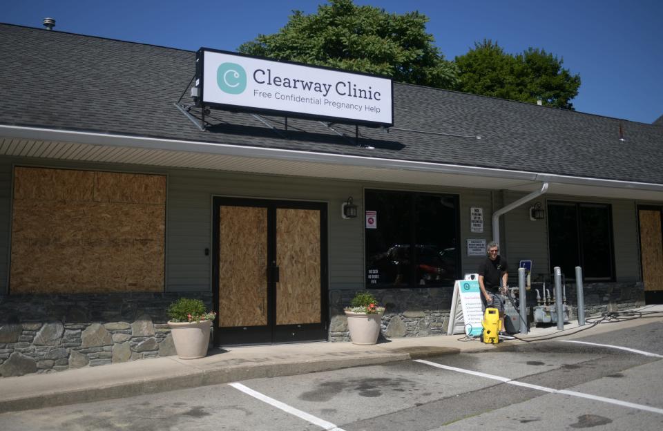 Windows are boarded up at the Clearway Clinic on Shrewsbury Street in Worcester, where vandals smashed windows and spray-painted "Jane's Revenge,"  an extremist abortion rights group, on the sidewalk.