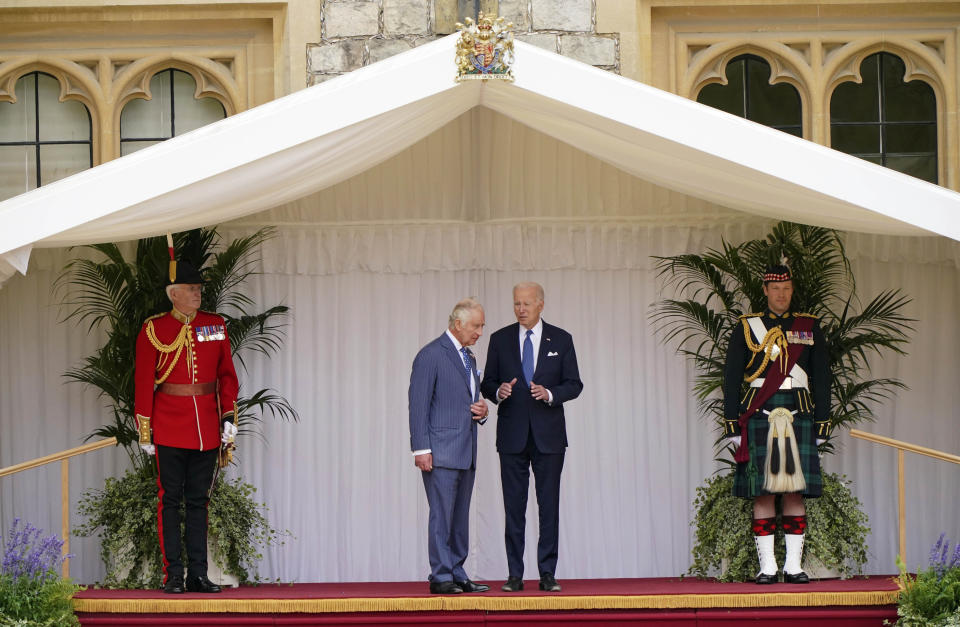 Britain's King Charles III and US President Joe Biden, right, during the welcome ceremony in the quadrangle at Windsor Castle, in Windsor, England, Monday July 10, 2023. (Jonathan Brady/Pool Photo via AP)