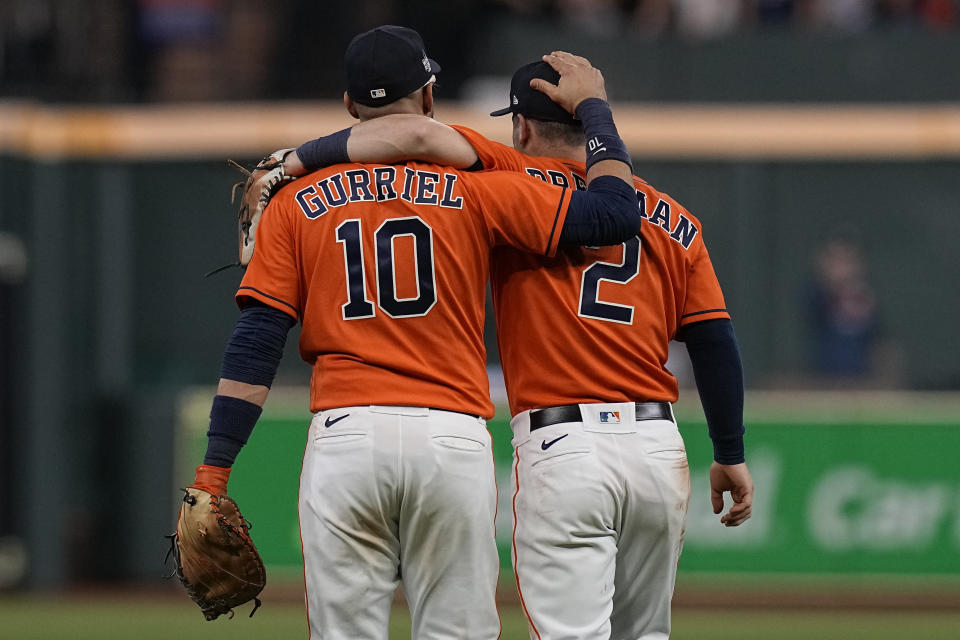 Houston Astros first baseman Yuli Gurriel and third baseman Alex Bregman hug after Game 2 of baseball's World Series between the Houston Astros and the Atlanta Braves Wednesday, Oct. 27, 2021, in Houston. The Astros won 7-2, to tie the series 1-1. (AP Photo/Eric Gay)