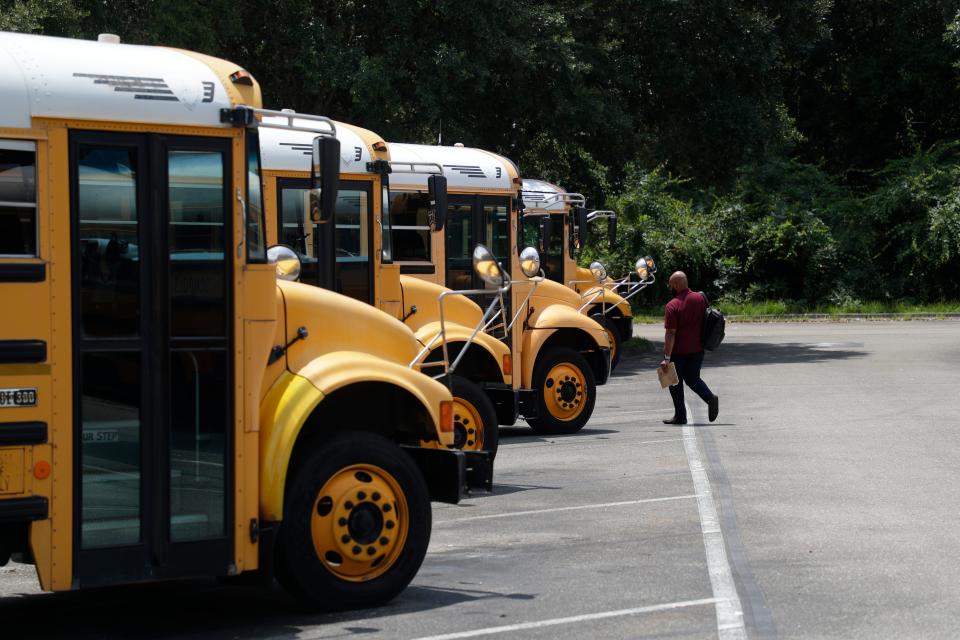 A Leon County Schools bus driver makes his way to a bus before afternoon pick-up at the Conner-Lakes Leon County Schools Bus Compound Tuesday, August 13, 2019. 