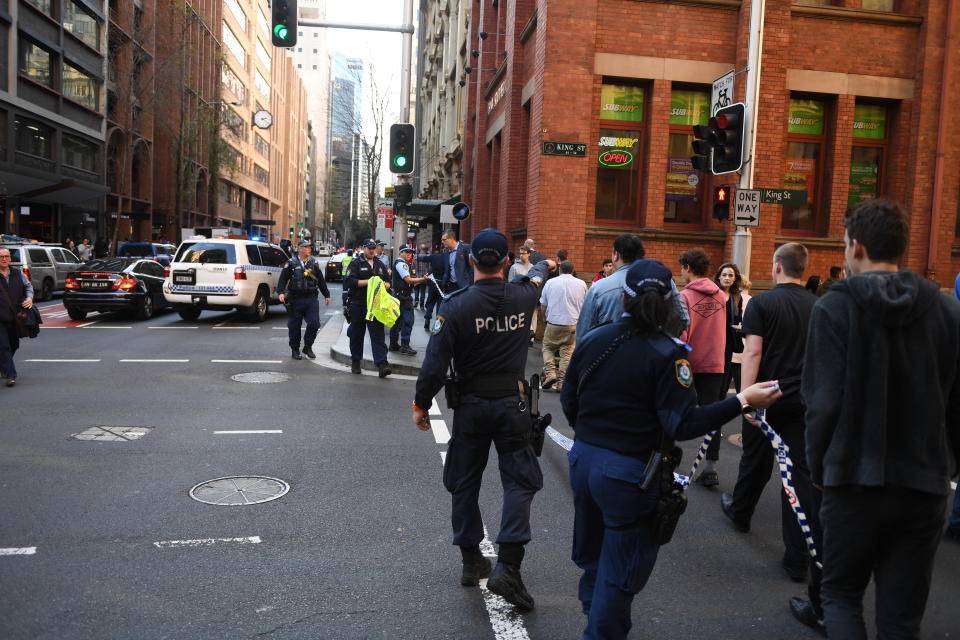 Police are seen during a police operation at the corner of King and York Street in Sydney, Tuesday, August 13, 2019. A police operation is underway in Sydney's CBD with multiple police, fire and ambulance vehicles racing to the scene amid reports of a stabbing. (AAP Image/Dean Lewins) NO ARCHIVING