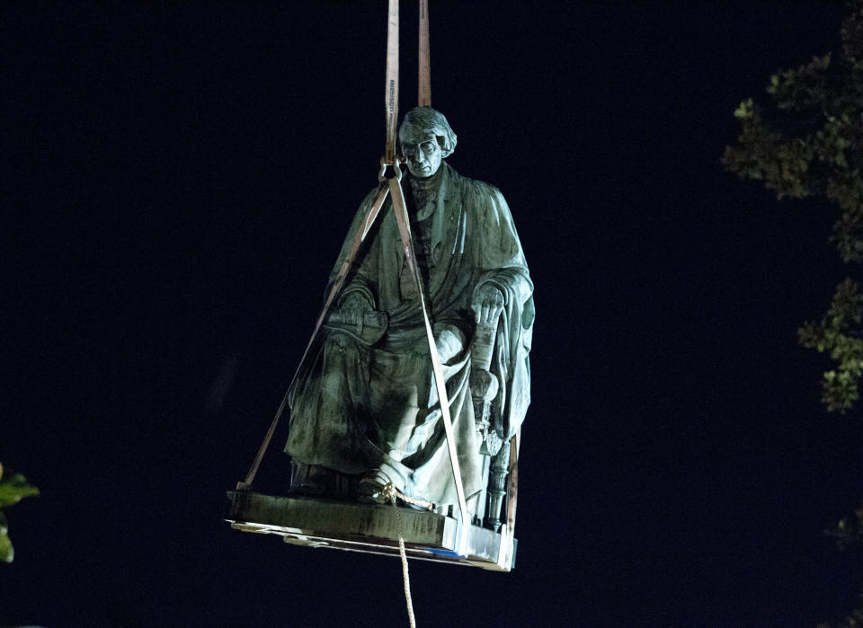 <p>Workers use a crane to lift the monument dedicated to U.S. Supreme Court Chief Justice Roger Brooke Taney after it was was removed from outside Maryland State House, in Annapolis, Md., early Friday, Aug. 18, 2017. Maryland workers hauled several monuments away, days after a white nationalist rally in Charlottesville, Virginia, turned deadly. (Photo: Jose Luis Magana/AP) </p>