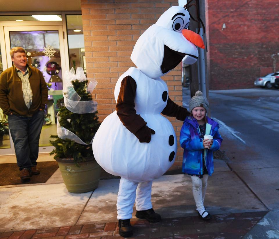 Olaf, a character from Disney's "Frozen" movie, poses with a fan during Nevada's Christmas on Main on Saturday, Dec. 11, 2021, in Nevada, Iowa.