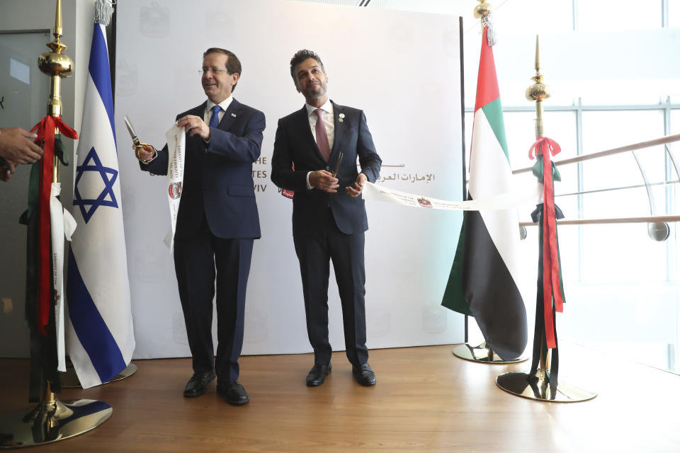 Israel's President Isaac Herzog, left, cuts a ribbon with United Arab Emirates ambassador to Israel Mohamed Al Khaja during the opening ceremony for the new UAE Embassy in Tel Aviv, Israel, Wednesday, July 14, 2021. (AP Photo/Ariel Schalit)