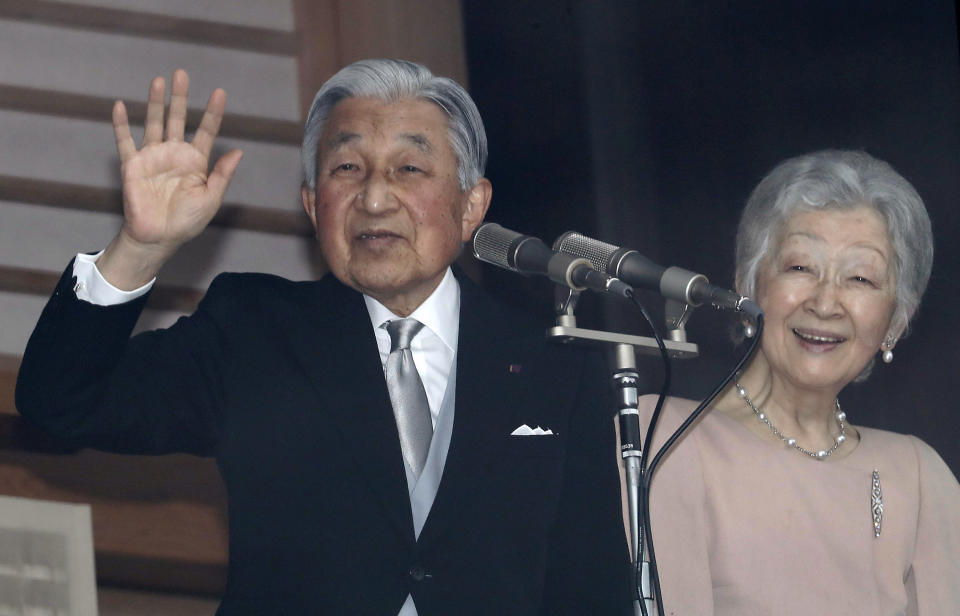 Japan's Emperor Akihito, left, accompanied by his wife Empress Michiko, right, waves to well-wishers as they appear on the balcony of the Imperial Palace to mark the emperor's 85th birthday in Tokyo Sunday, Dec. 23, 2018. (AP Photo/Eugene Hoshiko)